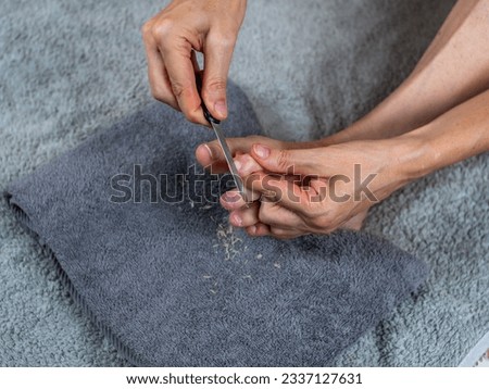 A woman polishes her nails with a nail file. Beautiful nail care process. Care for natural unpainted nails close-up. High-quality shooting in 4k format
