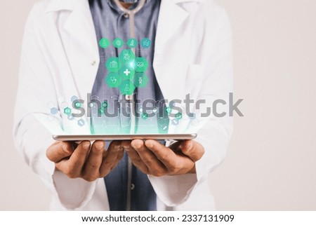 Doctor's Tech Toolkit: Handheld Device Displaying a Set of Technology Icons Royalty-Free Stock Photo #2337131909