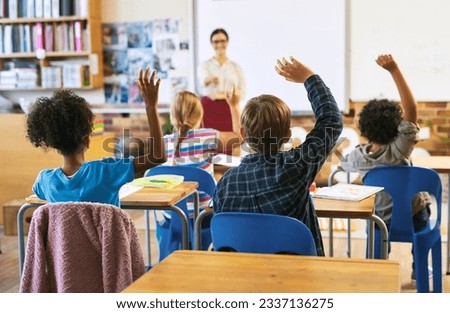 Education, question with group of children in classroom and raise their hands to answer. Learning or support, diversity and teacher teaching with young students in class of school building together Royalty-Free Stock Photo #2337136275