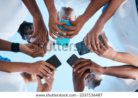 Hands, phone and app with people in a huddle or circle for communication or connectivity. Mobile, social media or information sharing with a group of men networking together closeup from below Royalty-Free Stock Photo #2337136487