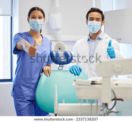 Dentist team, face mask and thumbs up portrait for.medical industry and teamwork. Assistant woman and asian man or healthcare staff together for dental care, oral health and wellness at practice Royalty-Free Stock Photo #2337138207