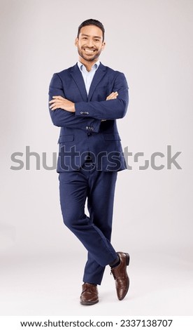 Business man, arms crossed and smile in studio portrait for pride, success or suit by white background. Young asian entrepreneur, happy and excited for finance company, accounting and fashion for job