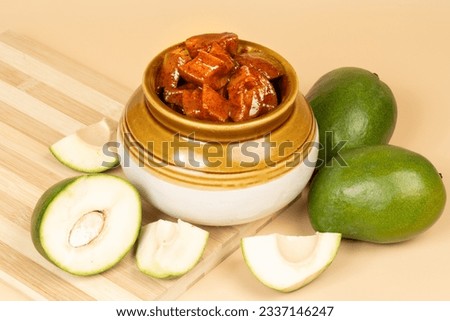 Andhra traditional home made raw mango sweet and spicy  pickle in a traditional pickle jar placed on a clean light brown  background- Selective focus
 Royalty-Free Stock Photo #2337146247