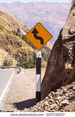 Curve sign on mountain road in Andes, Peru