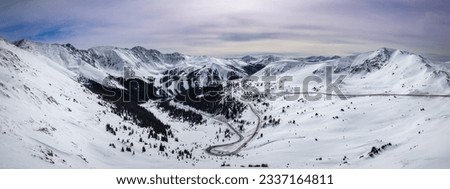 Breathtaking winter snow beauty of Loveland Pass, Colorado. Mountains and winding roads adventure and exploration. Nature's majesty with picturesque photo for travel, outdoor, or landscape project.