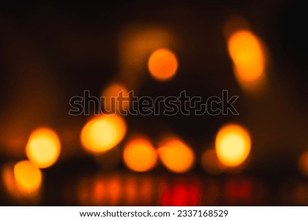 Flames in a fireplace, abstract blurred background photo with yellow lights, natural  bokeh effect