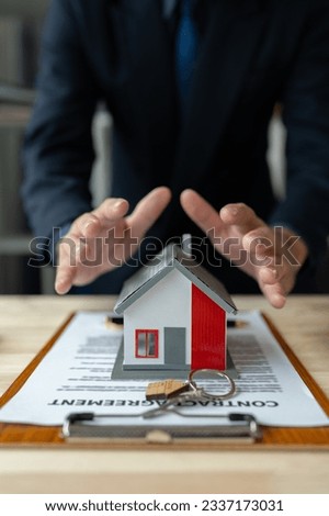 Property insurance, real estate broker or home insurance agent gesture protect house, house key, contract document, security concept, protection. Insurance rent buy sell mortgage