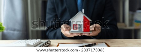 Businessman, real estate agency handing over home designs to clients after agreeing to buy and sell the house Rent and loan agreement insurance at the office