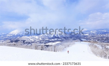 Beautiful mountains and Ski slope of Rusutsu ski resort in Hokkaido Japan. the best place for skiing. People are skiing and snowboarding . powder snow.
