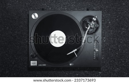 DJ turntable vinyl record on desk Royalty-Free Stock Photo #2337173693