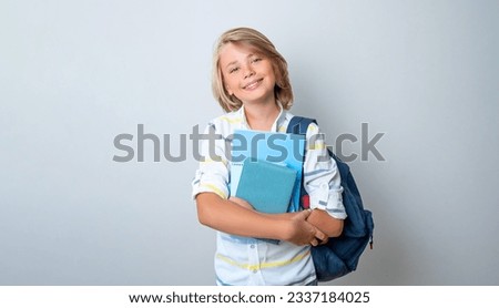 Middle school smiling teen boy girl backpack white background looking at camera holding books Copy space for advertising blank Back to school. Childhood, education, products for children Royalty-Free Stock Photo #2337184025