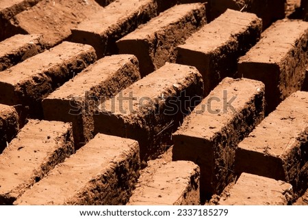 Man building with his hands an adobe house with adobe bricks and mud. Llachon region of Lake Titicaca in Peru. Royalty-Free Stock Photo #2337185279