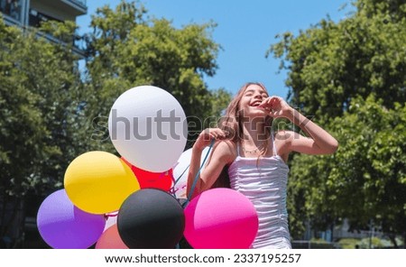 Happy girl with balloons Ten-year-old laughing and having fun in the park Great for fashion and lifestyle concept