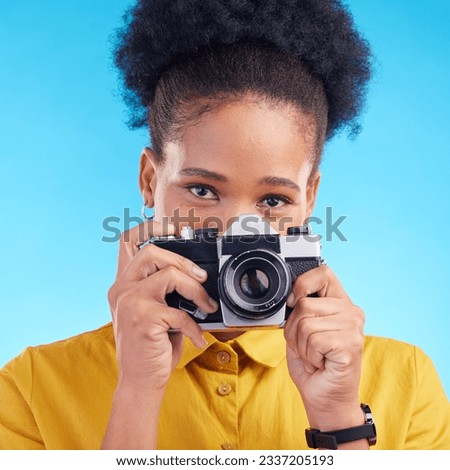 Photographer, portrait and camera, black woman isolated on blue background, creative artist job talent. Art, face of happy girl in photography hobby or career in studio on travel holiday photoshoot.