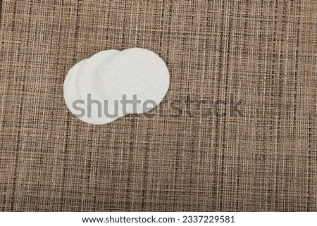 Cotton Disks, Hygiene Pads on Eco Linen Background, Round Facial Sponge, Skin Care Concept, Soft Clear Disk Stack Top View, Copy Space