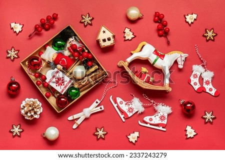 Handmade christmas care package, seasonal gift box with toys, xmas decor on red table Personalized eco friendly basket for family, friends, girl for 24 December, Christmas, New Year day Flat lay Royalty-Free Stock Photo #2337243279
