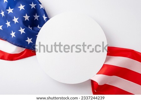 Paying tribute to the American public holiday: A striking top-down shot showcasing the American flag against white backdrop. Ample circle for advertisements or text placement during the celebration