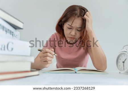 Asian student woman have anxiety because of exams, female prepare for test and learning lessons in the library. stress, despair, haste, misunderstanding reading, discouraged, expectation, knowledge