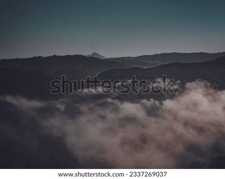 Foggy view on a hill called Pentulu Indah in Kebumen in the morning. Landscape photo