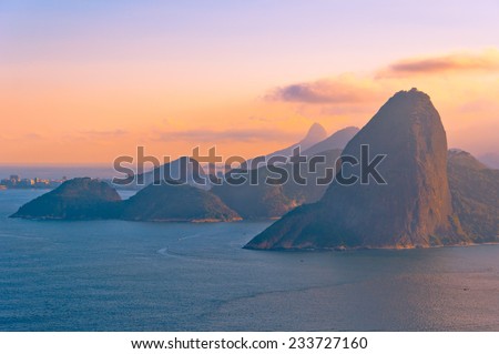 Sugarloaf Mountain from Behind during Red Sunset with View of Hills and Ocean, RIo de Janeiro, Brazil