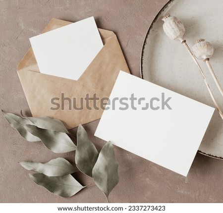 Cards mockup, envelopes and dried flowers top view on beige textured background with copy space. flatlay. Blank, greeting card template.