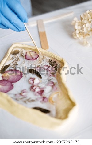 Side hustle, Money-Making Crafts, DIY Crafts To Create and Make Money. Epoxy Resin Art. Creating Art with Resin on workshop. The art process of creating epoxy resin handmade staff in art studio. Royalty-Free Stock Photo #2337295175