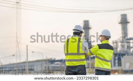 Group Asian man petrochemical engineer working at oil and gas refinery plant industry factory,The people worker man engineer work control at power plant energy industry manufacturing Royalty-Free Stock Photo #2337298301