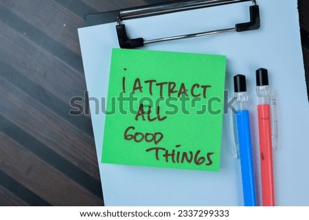 Concept of I Attract All Good Things write on sticky notes isolated on Wooden Table.