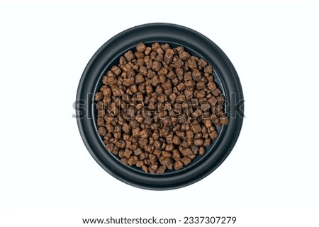  Round feeding bowl with dog or cat kibble seen directly above. Isolated on a white background.