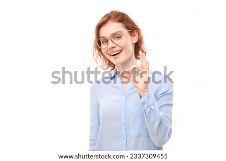 Portrait of young girl showing OK sign with fingers isolated on white background. Successful career, accepted concept
