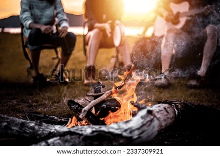 Picnic and camping tent, Adventure, travel, tourism, friendship and Recreation Concept. Group of asian tourists man and woman enjoying after a set up outdoor tent playing music around fire camp. Royalty-Free Stock Photo #2337309921