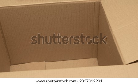 open cardboard boxes close-up, different angles, selective focus, cutout for handle in cardboard box