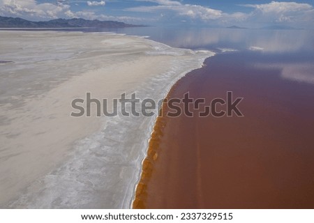 Aerial view of the pink lake with white salt beach in Utah. Pink lake is part of the Salt Lake in Utah, United States.