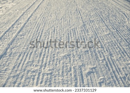 Ski track in winter. Place for winter sports. Prepared ski slope. Loose snow.