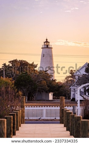 Ocracoke Lighthouse on Ocracoke Island , North Carolina at sunset.The lighthouse was built to help guide ships through Ocracoke Inlet into Pamlico Sound.