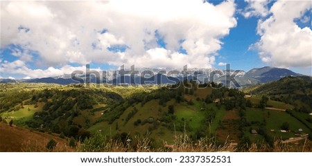 Panoramic picture of a Transylvanian landscape, where in the close-up the light comes out of the clouds and in the distance you can see a mountain range.