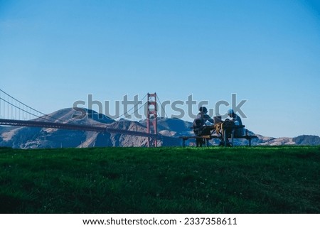 friends having a picnic in front of the golden gate in a park Royalty-Free Stock Photo #2337358611