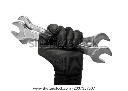 Man's hand  in a work glove holds a spanners isolated on white background