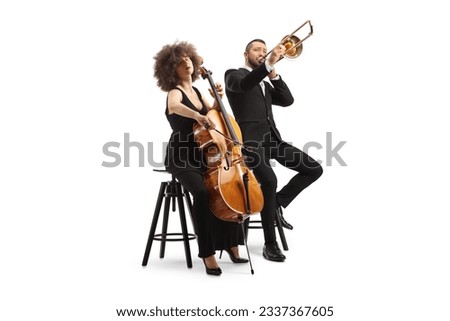 Young woman playing a cello and man playing sax isolated on white background Royalty-Free Stock Photo #2337367605