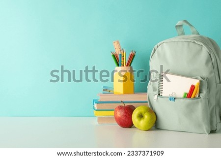 Enliven the classroom atmosphere with side-view image of cheerful school supplies, penholder, books and rucksack on white desk on blue isolated background, offering space for text or advert inclusion Royalty-Free Stock Photo #2337371909
