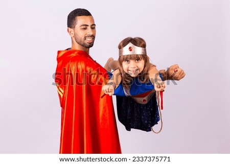 Father and daughter in hero costume playing on white background with free space for text. Father's Day