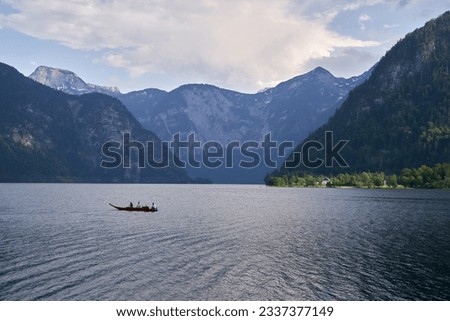Colorful view of famous Hallstatt lake,  Boat and Austrian Alps. Salzkammergut region, Austria.