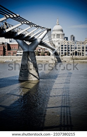 Majestic London Bridge over River Thames, with iconic St. Paul's Cathedral backdrop. Captures London's essence.