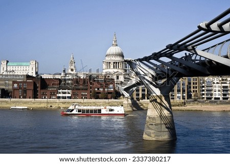 Majestic London Bridge over River Thames, with iconic St. Paul's Cathedral backdrop. Captures London's essence.
