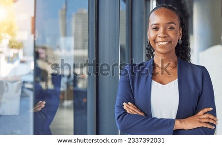 Portrait, window and arms crossed with a business black woman standing in her professional office. Smile, corporate leadership with a happy female manager or boss in the workplace for empowerment Royalty-Free Stock Photo #2337392031