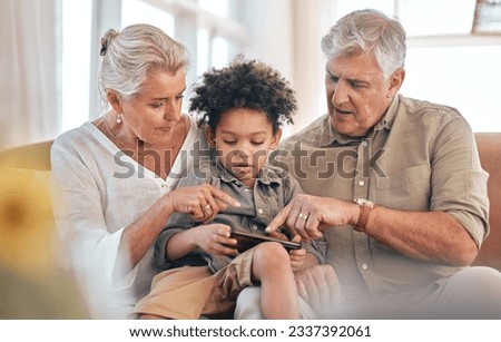 Grandparents, phone and child in home pointing, learning and bonding together in living room. Smartphone, biracial kid and grandpa and grandma in lounge streaming movie, video or film on social media Royalty-Free Stock Photo #2337392061