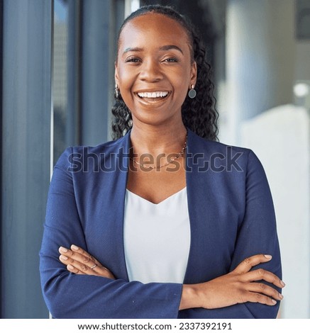 Portrait, smile and arms crossed with a business black woman standing in her professional office. Corporate, leadership and confidence with a happy female manager in the workplace for empowerment Royalty-Free Stock Photo #2337392191