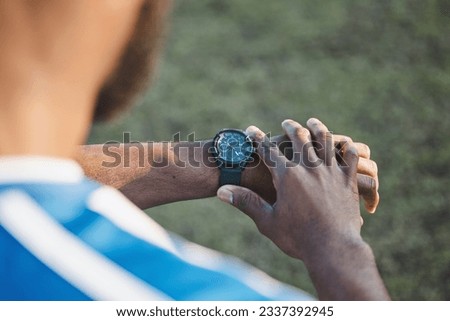 Hands, man or soccer player with smart watch on field to monitor time, training or exercise progress. Wellness, performance or healthy sports athlete with timer to check running workout or fitness Royalty-Free Stock Photo #2337392945
