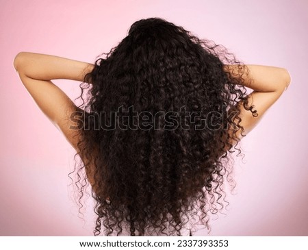 Hair, beauty and back of woman with hairstyle transformation and curly texture. Model, salon treatment and haircut shine in a studio with pink background and cosmetics with keratin and growth care Royalty-Free Stock Photo #2337393353