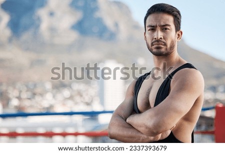 Man, wrestling and arms crossed in portrait for sport, ring and fitness on rooftop, strong muscle and mindset. Young athlete, serious face and healthy body for fight, mma and training in Cape Town